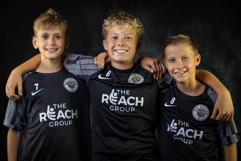 Three Child Football Players wearing Balanced FC kit